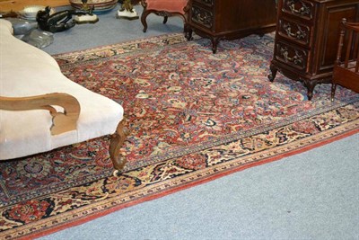 Lot 1274 - Saroukh Carpet West Persia The blood red field with an allover design of flowers and palmettes...