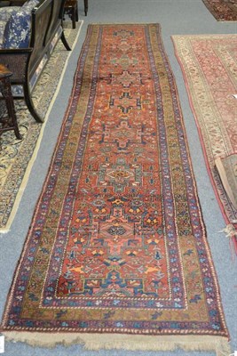 Lot 1278 - Narrow Heriz Runner Persian Azerbaijan The rust field with a column of typical medallions...