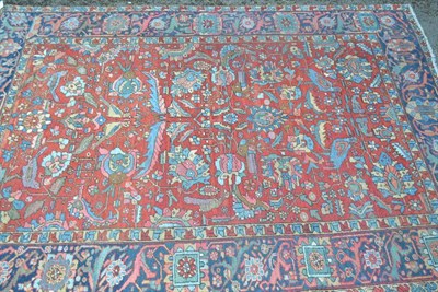 Lot 1284 - Heriz Carpet Persian Azerbaijan The crimson field of angular vines, flowerheads and birds...