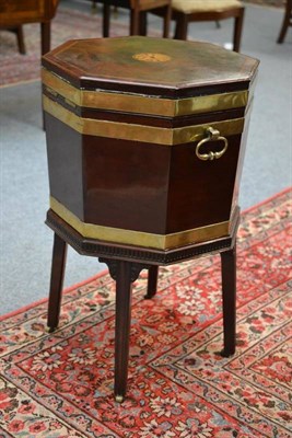 Lot 1300 - A George III Mahogany Octagonal Wine Cooler, circa 1800, the hinged lid with floral patera...