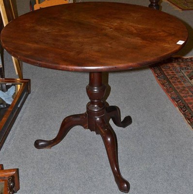 Lot 1301 - A George III Mahogany Tripod Table, late 18th century, with flip top, turned vasiform support,...