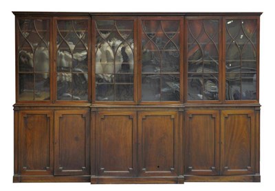 Lot 1303 - A George III Mahogany Breakfront Library Bookcase, early 19th century, the astragal glazed...