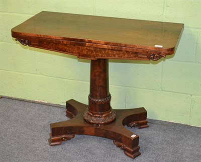 Lot 1304 - A George IV Plum Pudding Mahogany Foldover Card Table, circa 1820, the rounded rectangular foldover