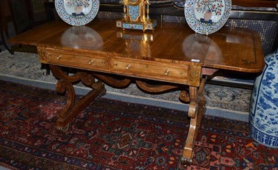 Lot 1305 - A Regency Rosewood and Brass Inlaid Sofa Table, early 19th century, the two rounded drop leaves...