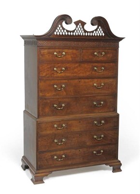 Lot 1323 - A George III Mahogany Chest on Chest, circa 1800, the broken swan neck pediment above a dentil...