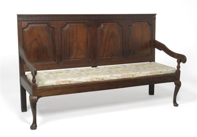 Lot 1331 - A George III Mahogany Settle, late 18th century, with four fielded panels and blind fret carved top