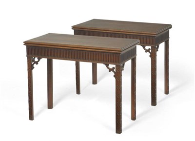 Lot 1346 - A Pair of George III Carved Mahogany Chippendale Revival Foldover Card Tables, the hinged lids...