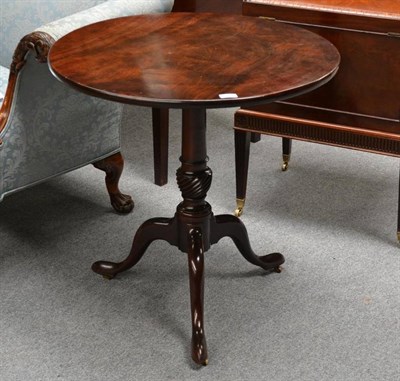 Lot 1362 - A George III Mahogany Tripod Table, late 18th century, the circular flip-top above a turned and...