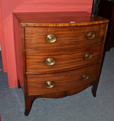 Lot 1370 - A George III Style Mahogany Bowfront Chest, with three deep drawers above a shaped apron, raised on