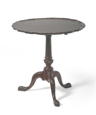 Lot 1376 - A George II Style Mahogany Tripod Table, the circular pie crust moulded top above a turned vasiform