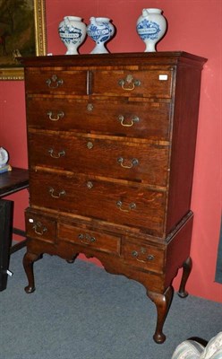 Lot 1391 - An 18th Century Oak and Mahogany Crossbanded Chest on Stand, the cavetto cornice above two...