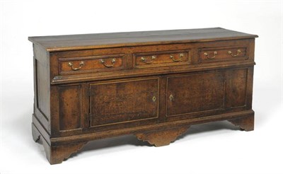 Lot 1394 - An Early 18th Century Joined Oak Enclosed Dresser Base, the moulded top above three frieze...