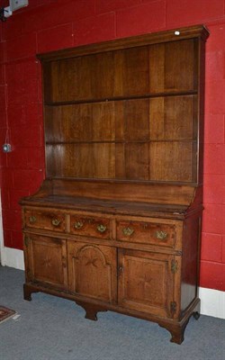 Lot 1395 - A George III Oak Enclosed Dresser and Rack, late 18th century, with three fixed shelves above three