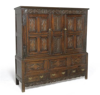 Lot 1397 - An 18th Century Joined Oak Press Cupboard, the carved frieze above two cupboard doors with...