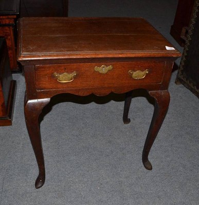 Lot 1399 - An 18th Century Joined Oak Lowboy, the moulded top above a frieze drawer and wavy shaped apron,...