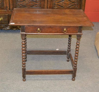 Lot 1403 - An Early 18th Century Oak Side Table, the four plank top with cleated ends above a frieze...