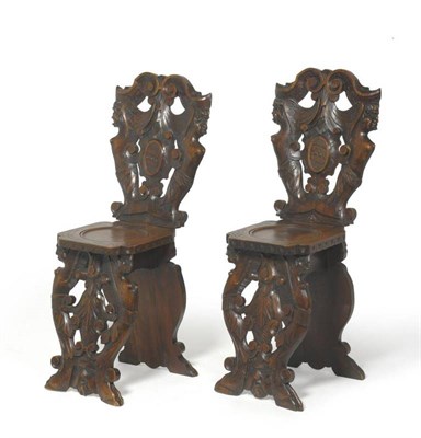 Lot 1408 - A Pair of Late 19th Century Florentine Walnut Sgabello Hall Chairs, with C scroll rail and...