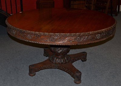 Lot 1421 - A 19th Century Anglo-Indian Padouk Centre Table, the circular top with leaf carved edge and frieze