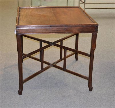 Lot 1425 - A Chinese Hardwood Folding Games Table, early 20th century, of rectangular form, fitted with...