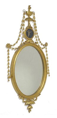 Lot 1439 - A George III Style Gilt and Gesso Pier Glass, late 19th century, the oval plate within a beaded and