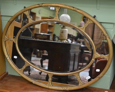 Lot 1442 - A Victorian Gilt and Gesso Oval Mirror, mid 19th century, the reeded and beaded oval frame with...