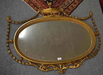 Lot 1443 - An Adams Style Gilt and Gesso Oval Wall Mirror, 19th century, the oval plate contained within...