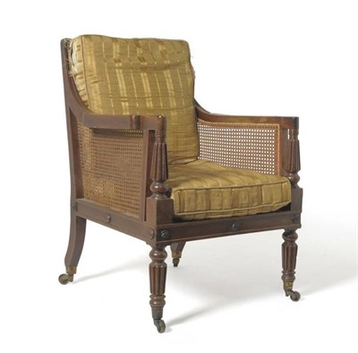 Lot 1448 - A William IV Mahogany Bergère Library Chair, 2nd quarter 19th century, with single canework...