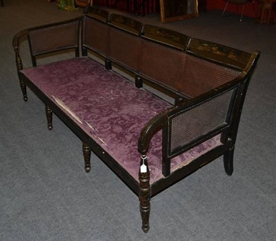 Lot 1450 - A Regency Black Japanned Four-Seater Settee, early 19th century, with single canework back...