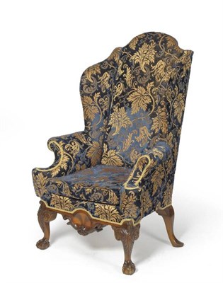 Lot 1456 - An Early Georgian Style Wing Back Chair, 20th century, recovered in gold silk damask, with...