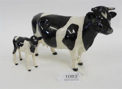 Lot 1083 - A Beswick Friesian cow and calf