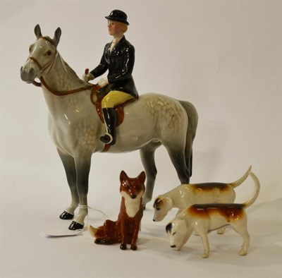 Lot 1184 - Beswick Huntswoman on Grey Horse, model No. 1730, gloss, 21cm high; Two Foxhounds; A Seated Fox (4)