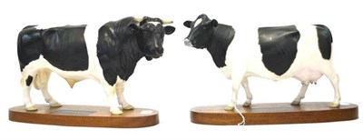 Lot 1037 - Beswick Friesian Bull, model A2580, on wood base; Beswick Friesian Cow, model number A2607 (2)