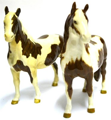 Lot 1144 - Beswick Skewbald Pinto Ponies, model No. 1373 first & second version, brown and white gloss (2)