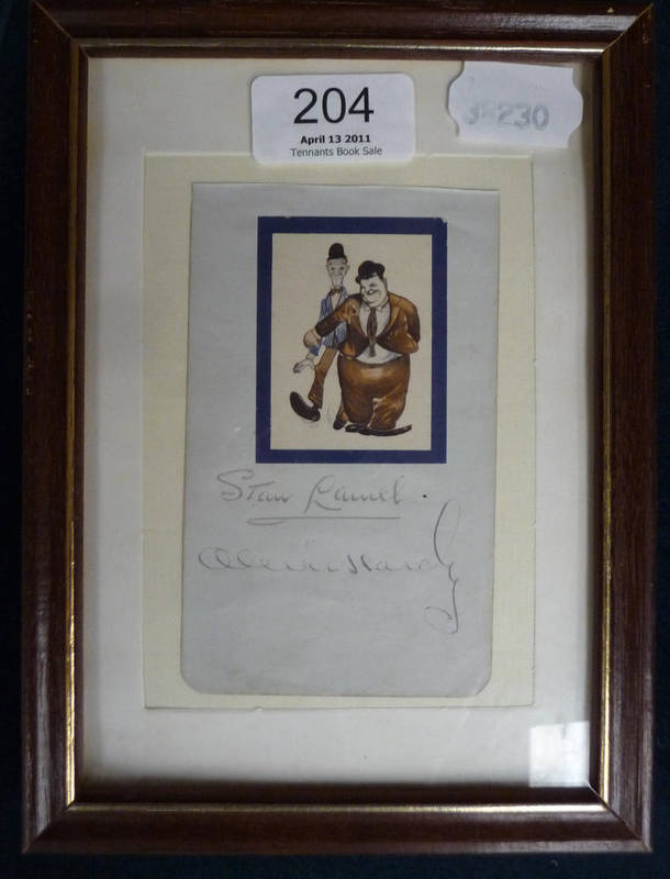 Lot 204 - Laurel and Hardy Autographs, with comic sticker, pen signatures, on a page from an autograph...