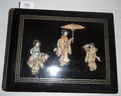 Lot 302 - A Japanese Black Lacquered Postcard Album, decorated with three bone and mother of pearl geishas to