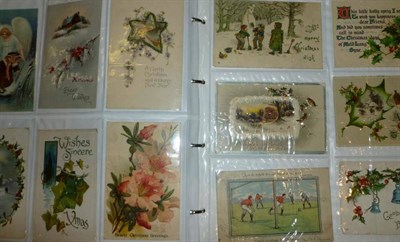 Lot 243 - An Album of Greetings Card Postcards, approximately four hundred and fifty pre-war cards, including