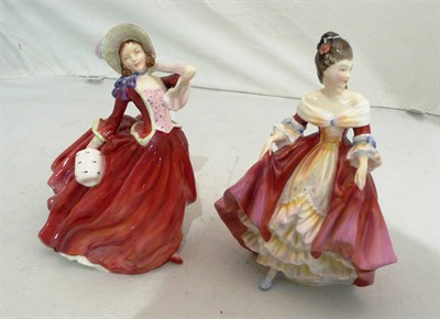 Lot 79 - Two Royal Doulton china figures 'Southern Belle' HN2229 and 'Autumn Breezes' HN1934