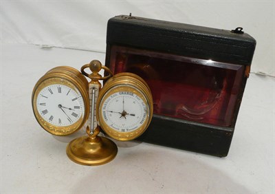 Lot 80 - A gilt brass compendium clock in a fitted outer case