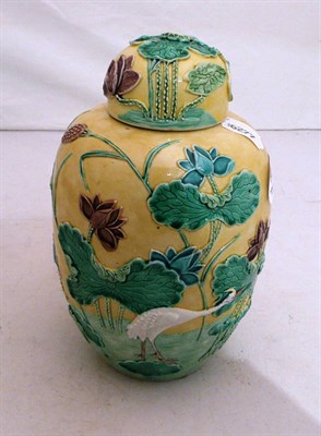 Lot 149 - An Oriental yellow ground relief-decorated jar and cover