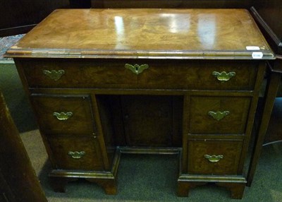 Lot 595 - George II style walnut kneehole dressing table