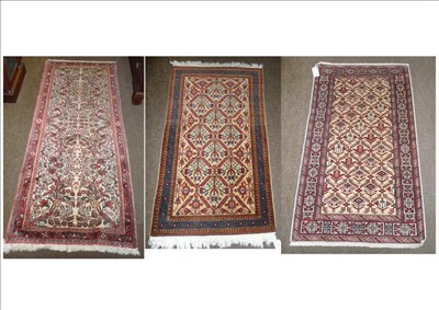 Lot 615 - Three modern silk fringed rugs