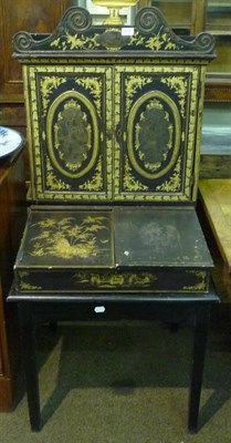 Lot 618 - A black and gilt lacquered cabinet on associated stand
