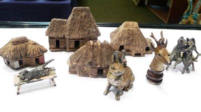 Lot 13 - Cold-painted bronze spelter rabbit, tape measure, three figures and four house ornaments