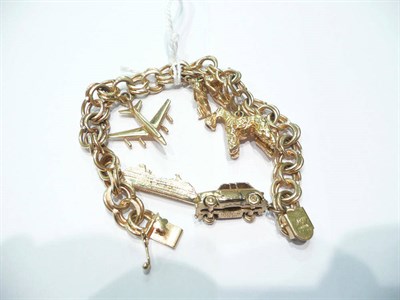 Lot 15 - A fancy bracelet stamped '14K' hung with assorted charms