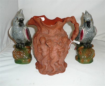 Lot 62 - Victorian earthenware figural pottery jug and two pottery parrots (3)