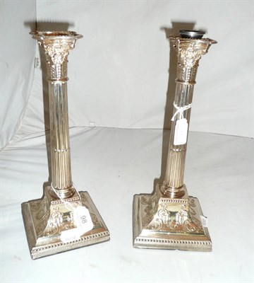 Lot 98 - A pair of silver plated Corinthian column candlesticks