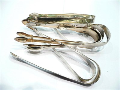 Lot 243 - Seven pairs of silver sugar tongs