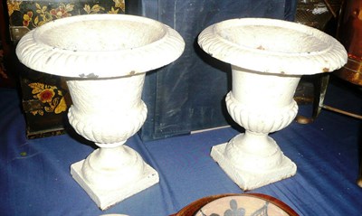 Lot 311 - A pair of Victorian cast iron white painted small urns