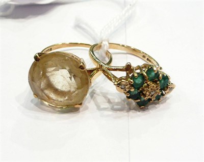 Lot 366 - A citrine ring and an emerald and diamond ring (2)