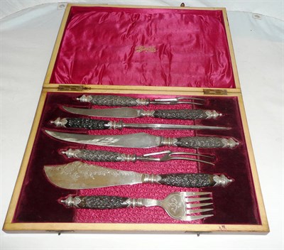 Lot 394 - A cased seven piece horn-handled carving set